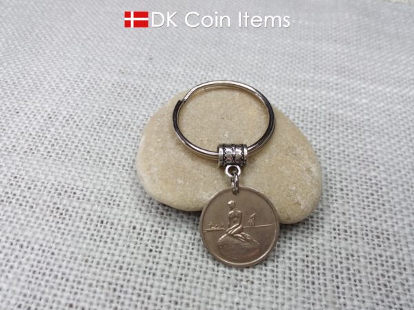 Denmark Little Mermaid coin keychain with Copenhagen Little Mermaid fare token.